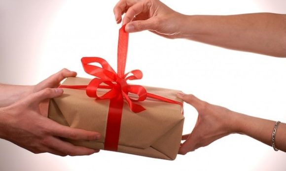 A wrapped gift being given
